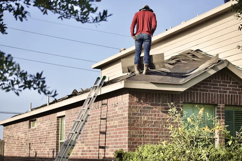 Professional roofer working on a residential roof in Klein
